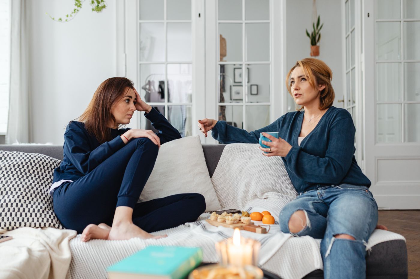Two women talking together in a quiet living room