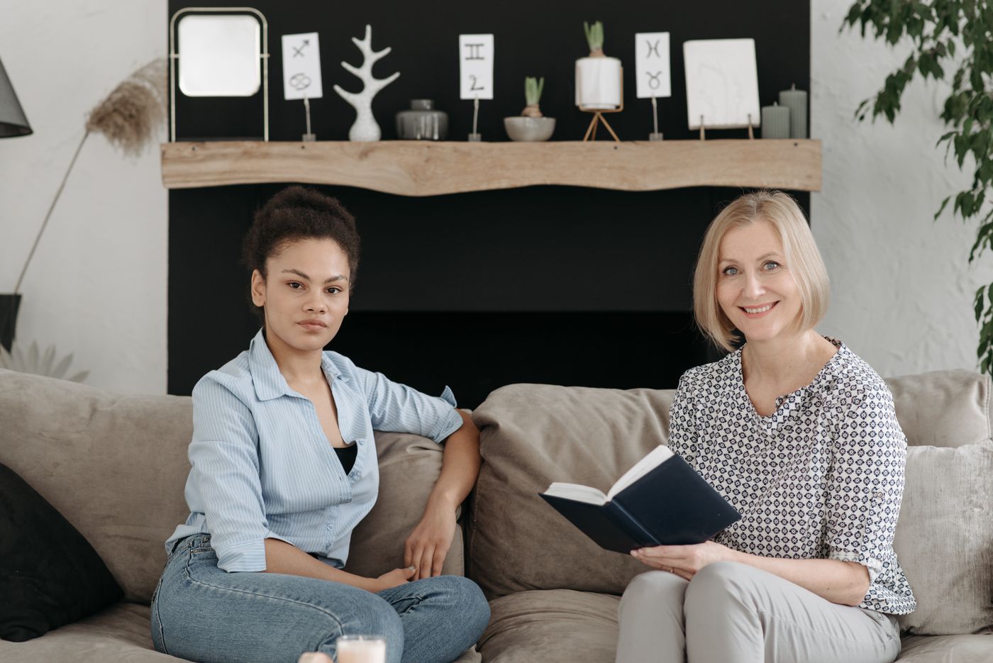 Two women seated together with a notebook